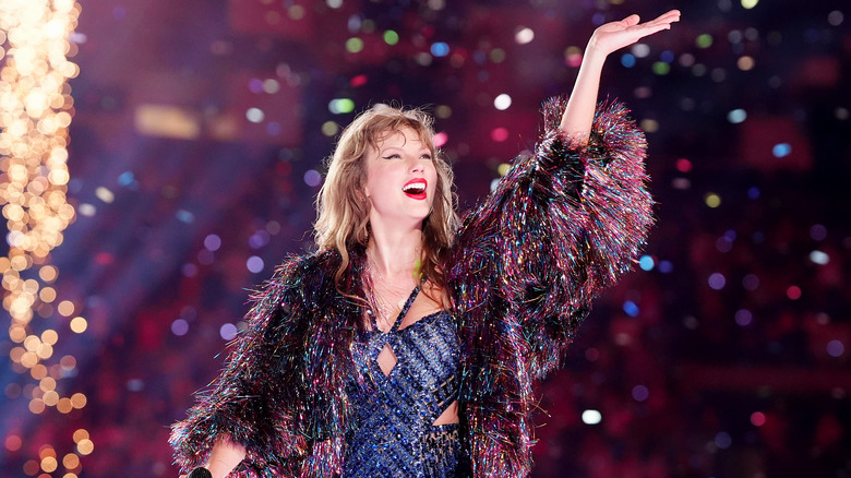 Taylor Swift waves during concert