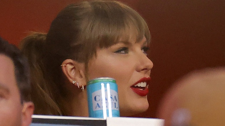 Taylor Swift sitting behind Casa Azul Tequila Soda can