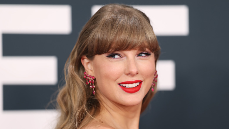 Taylor Swift wearing red lipstick and smiling