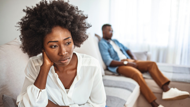 A woman looking disappointed at her partner 