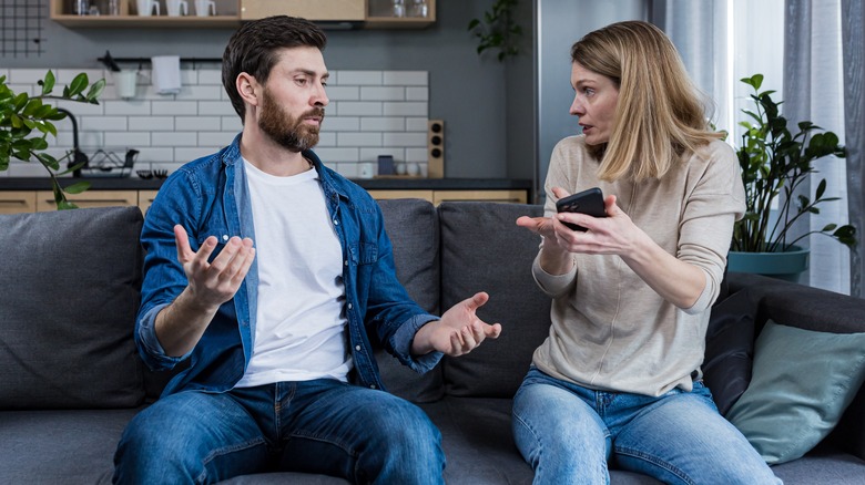 A couple arguing about something on a phone 