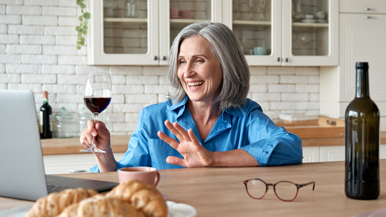 Senior woman smiling at online date