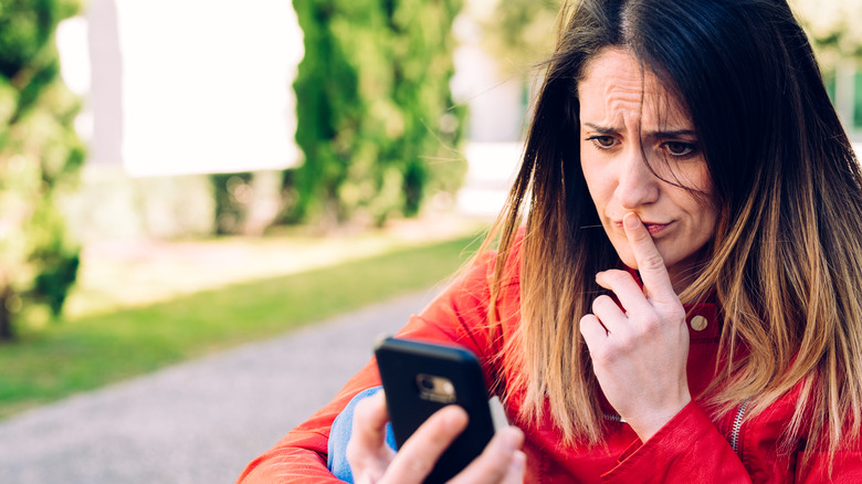 woman contemplating what to text