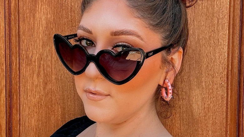 Woman wearing heart-shaped sunglasses