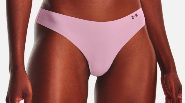 Model wearing purple thong panties