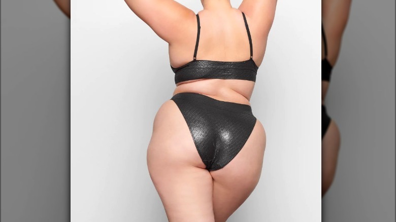 Model wearing black metallic underwear set