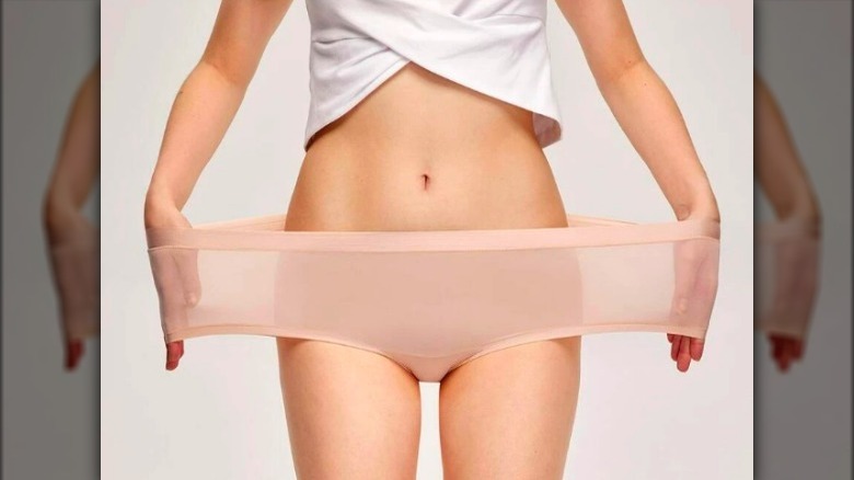 Model demonstrating strechy underwear material