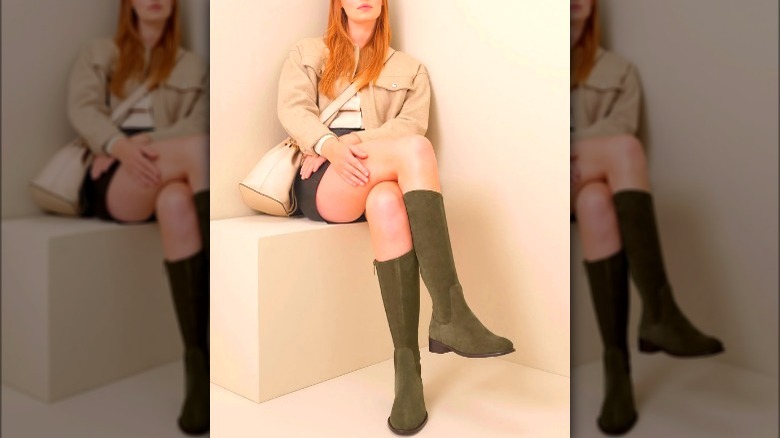 Woman wearing green knee-high boots