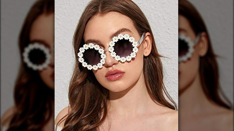 Woman wearing round daisy sunglasses