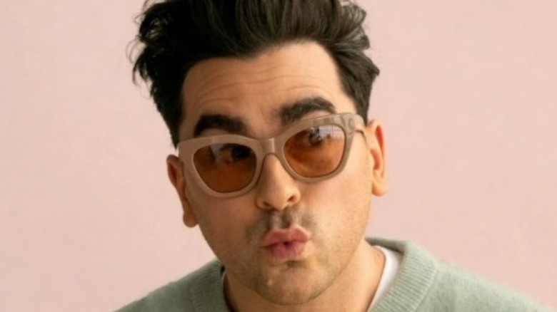 Dan Levy wearing tan sunglasses