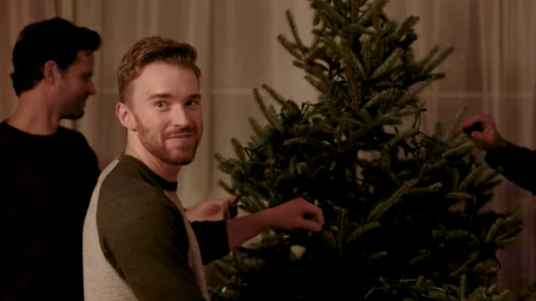 Chandler Massey decorating a tree in Next Stop, Christmas