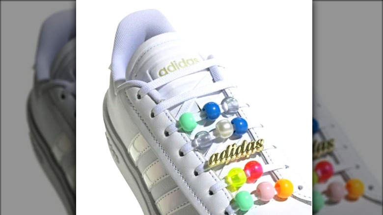 White Adidas sneakers with colorful beads