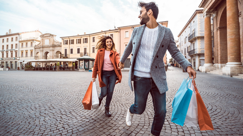 Two people carrying shopping bags