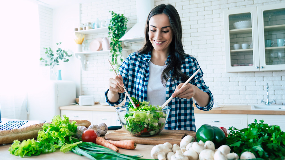 A woman making a salad 