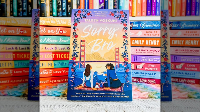 Sorry, Bro set against stacks of colorful romance novels from @thebookishlibra