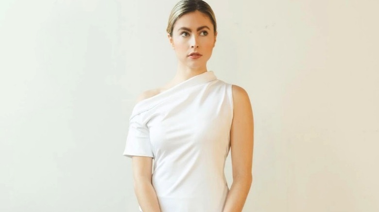 Model wearing white off the shoulder t-shirt