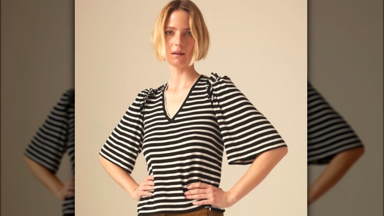 Model wearing black and white striped t-shirt