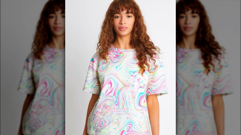 Model wearing brightly swirled t-shirt