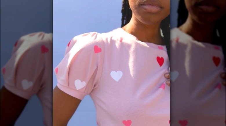 Model wearing pink t-shirt with hearts