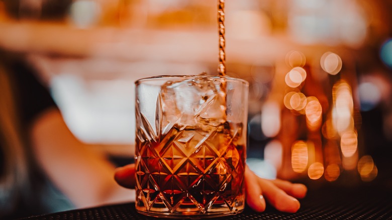 bartender stirring negroni