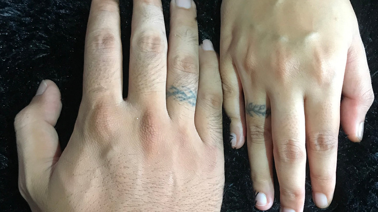 couple with tattoos on their ring fingers