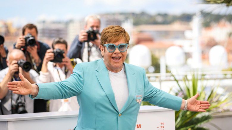 Elton John posing for paparazzi