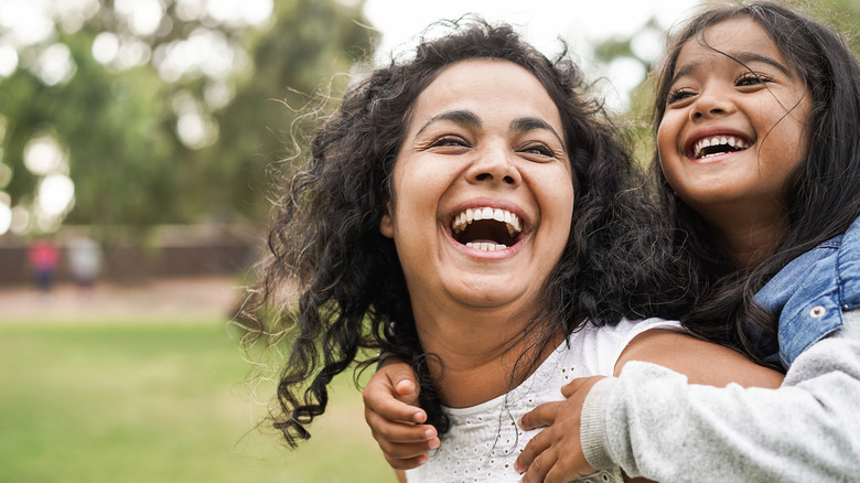 Mother and daughter smiling and laughing