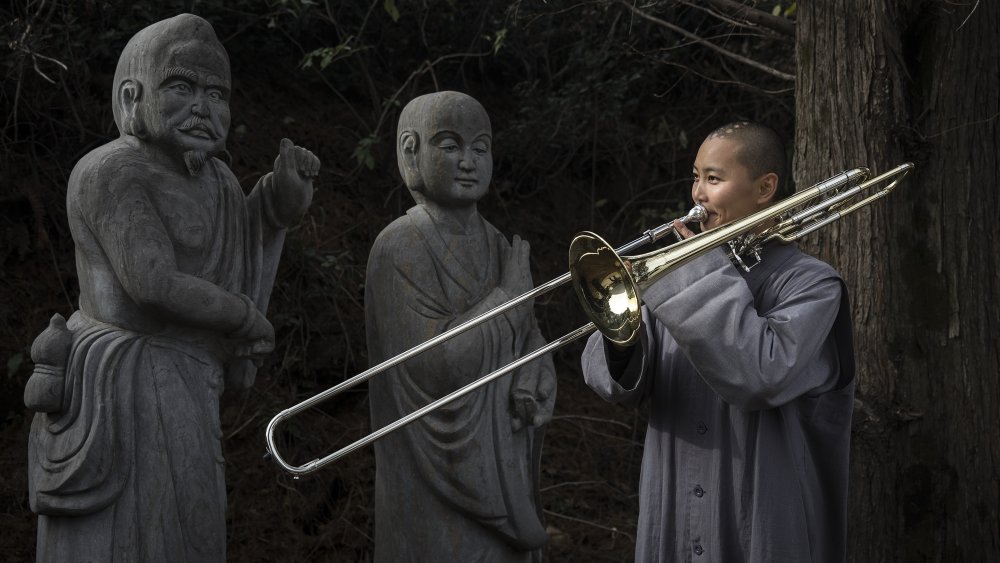 Buddhist nun playing trombone