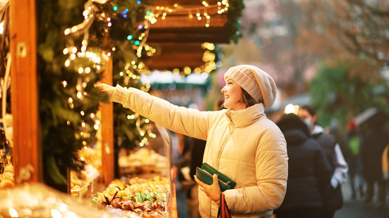 Woman shopping at Swiss-style christmas market 