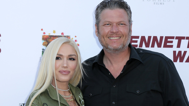 Gwen Stefani and Blake Shelton on red carpet smiling