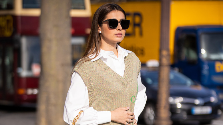 Woman wearing vest over shirt