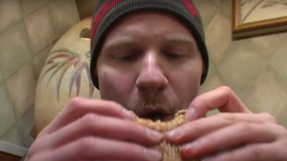 Man eats hamburger