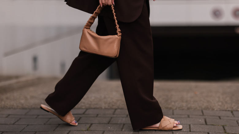 Woman in black pants and Ducie beige quilted slides