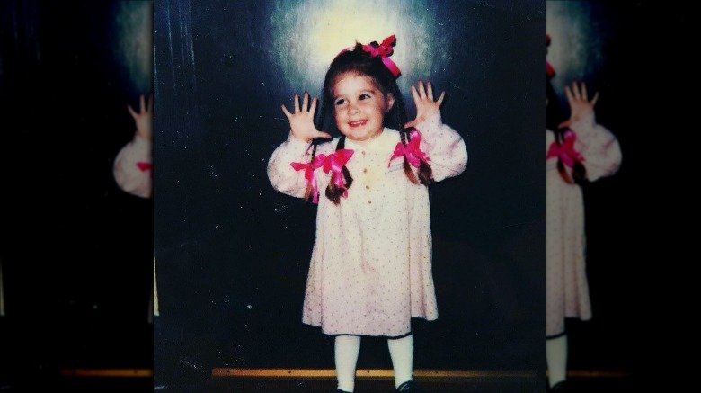 Alisan Porter as a toddler with bows in her hair