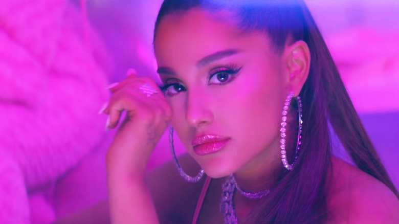 Ariana Grande wearing plumping lip gloss in the 7 Rings music video