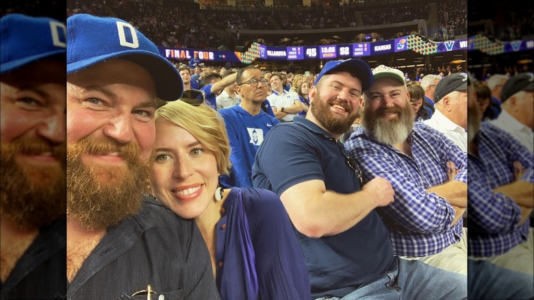 Ben and Napier smiling with their friends at a Duke sports game