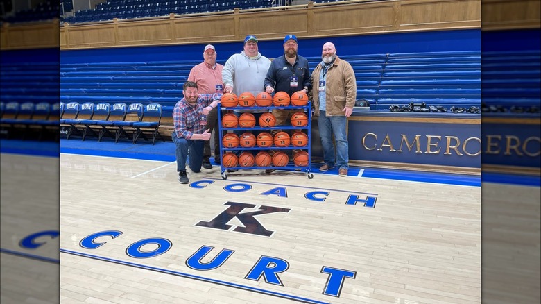Ben Napier, his brothers, and dad posing on the Duke University basketball court