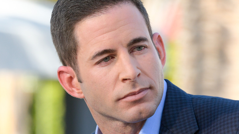 Tarek El Moussa looks over left shoulder