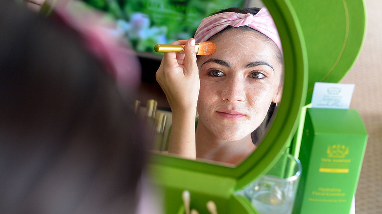 woman applying Tata Harper product