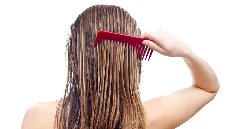 Woman combing wet hair