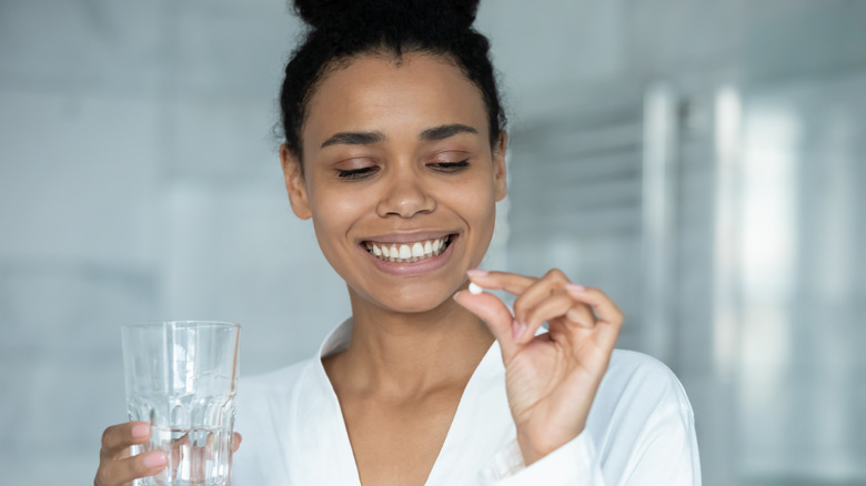 Woman taking astaxanthin supplements