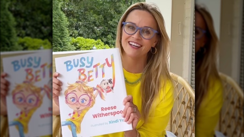 Reese Witherspoon holding her book