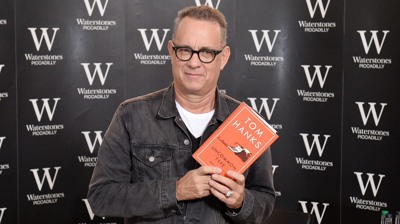 Tom Hanks holding his book Uncommon Type