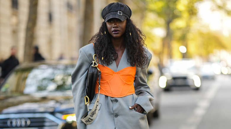 woman in neon outfit with saddle bag