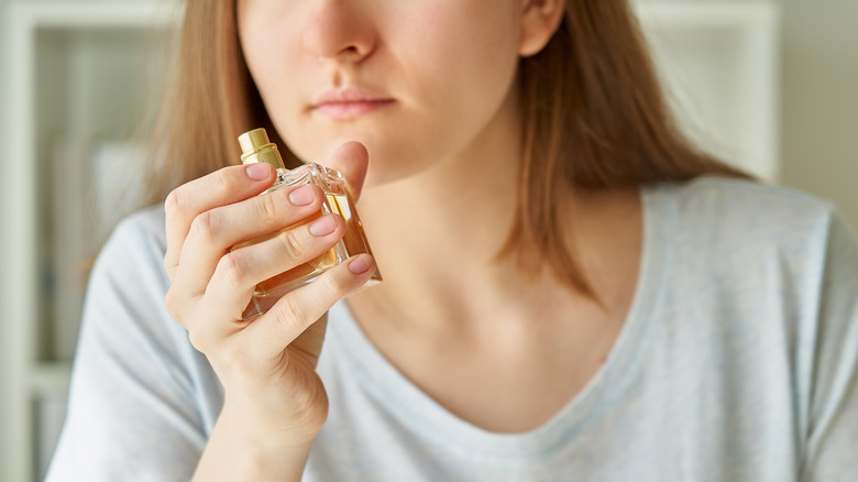 Woman smelling perfume