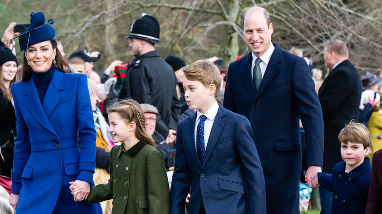 The Prince and Princess of Wales walking with their kids