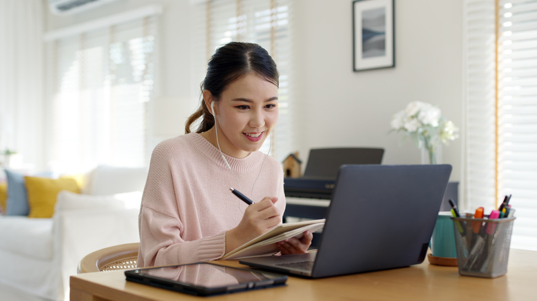 A smiling woman at her laptop