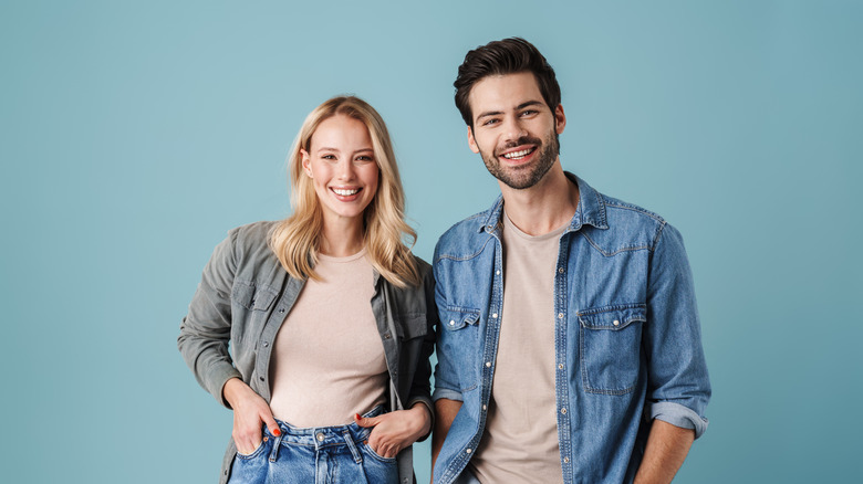 Two friends, a man and woman, smiling. 