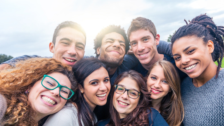 A group of friends embracing and smiling