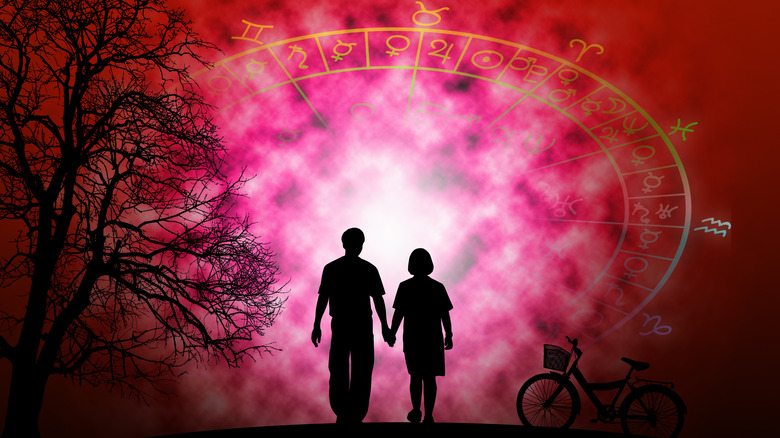 Two lovers walking beneath the zodiac wheel 